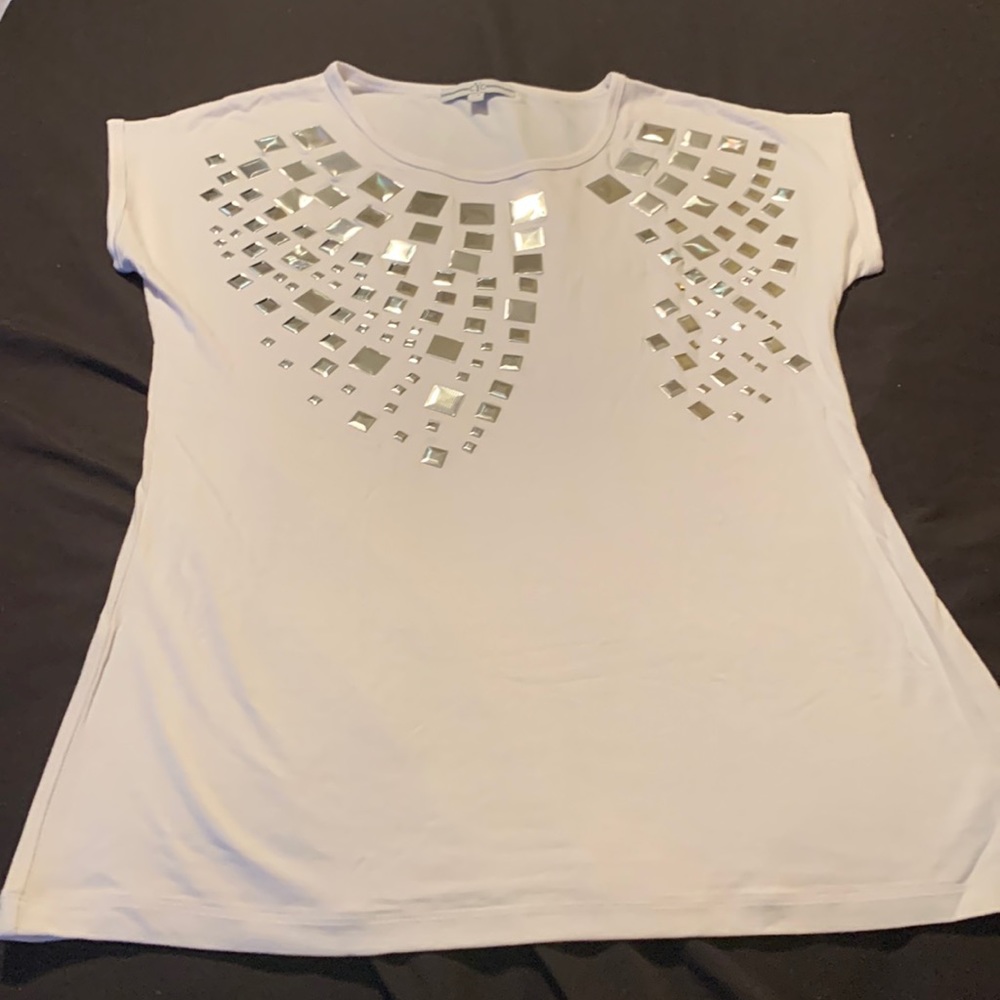 Woman’s dress top with silver metallic details.